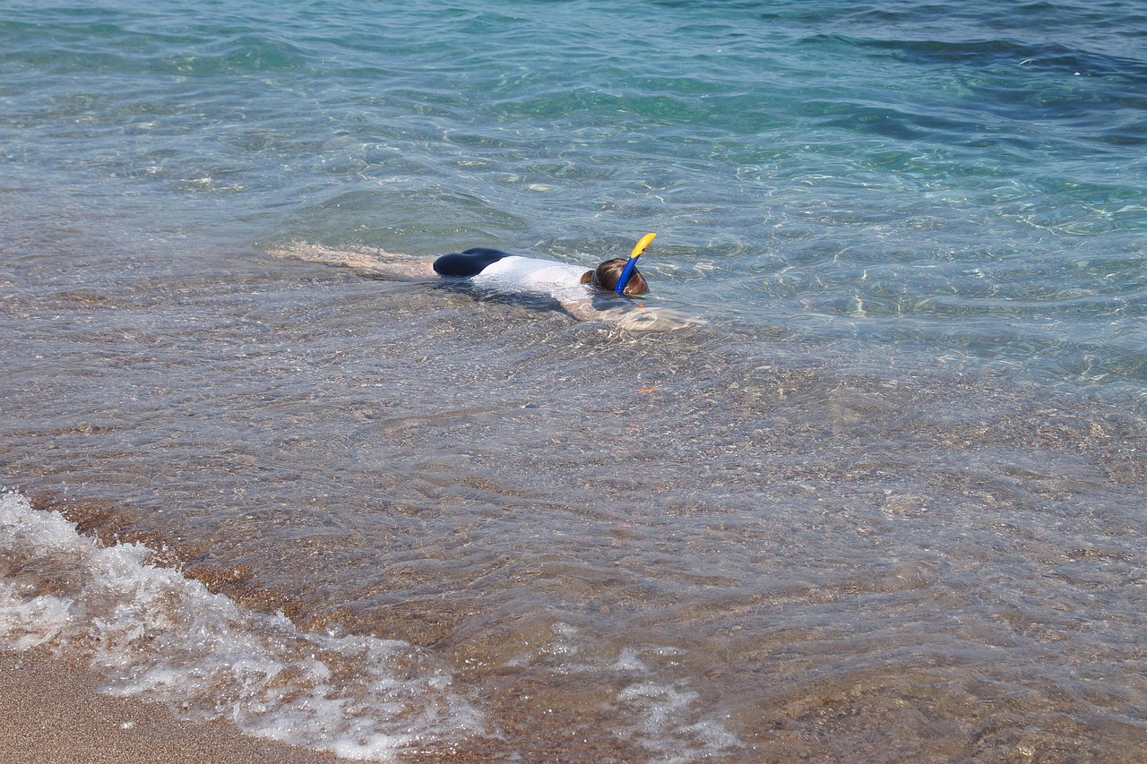 Child snorkeling in clear ocean water representing family activities available in Palawan Philippines