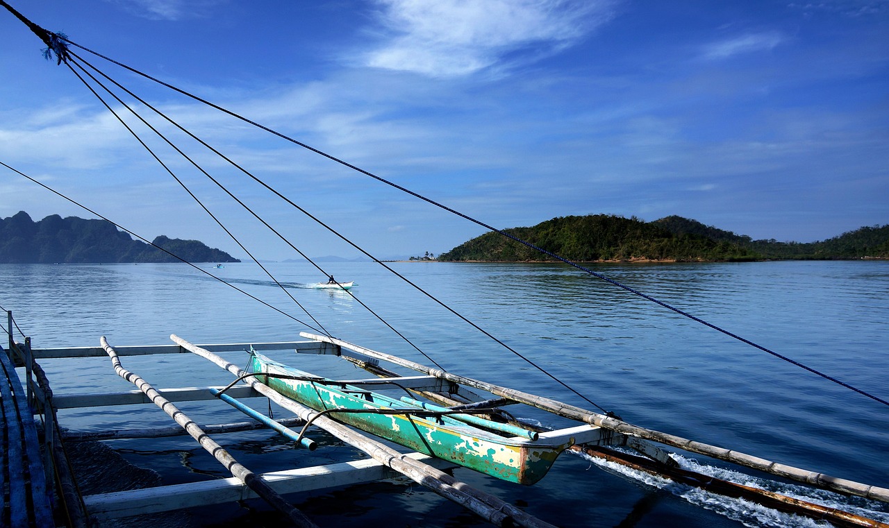 Traditional bangka boat on calm sea in El Nido Palawan during wet season island hopping tour