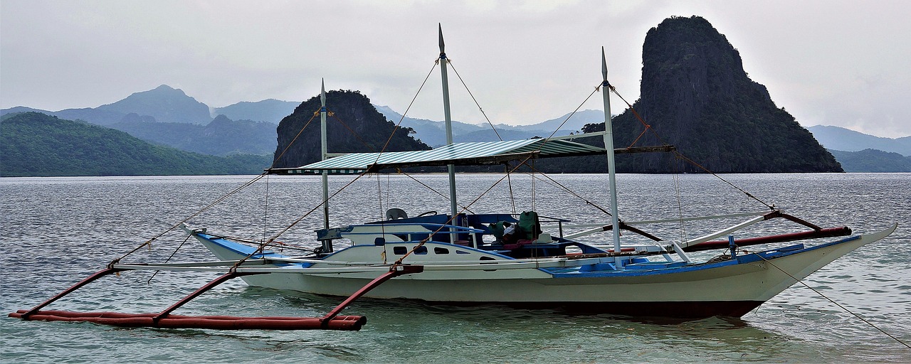 Traditional bangka boats on turquoise water in El Nido Palawan for sustainable island hopping tours