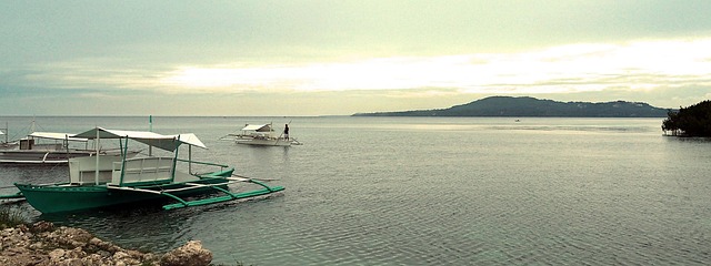 Outrigger bangka boat on calm clear water - how to get to Balabac Island Palawan