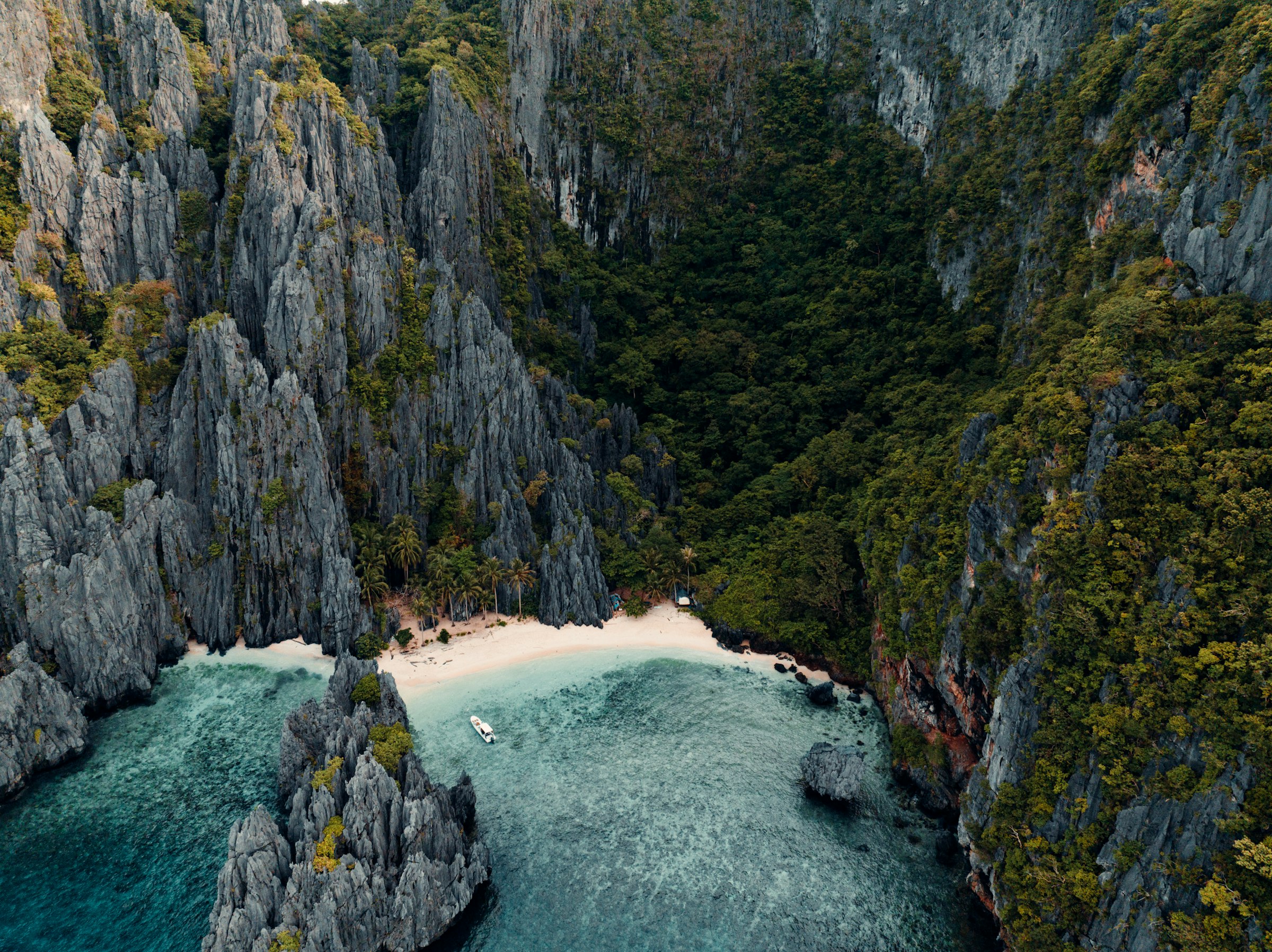 Turquoise lagoon cove with limestone cliffs on El Nido Tour A, Bacuit Bay Palawan