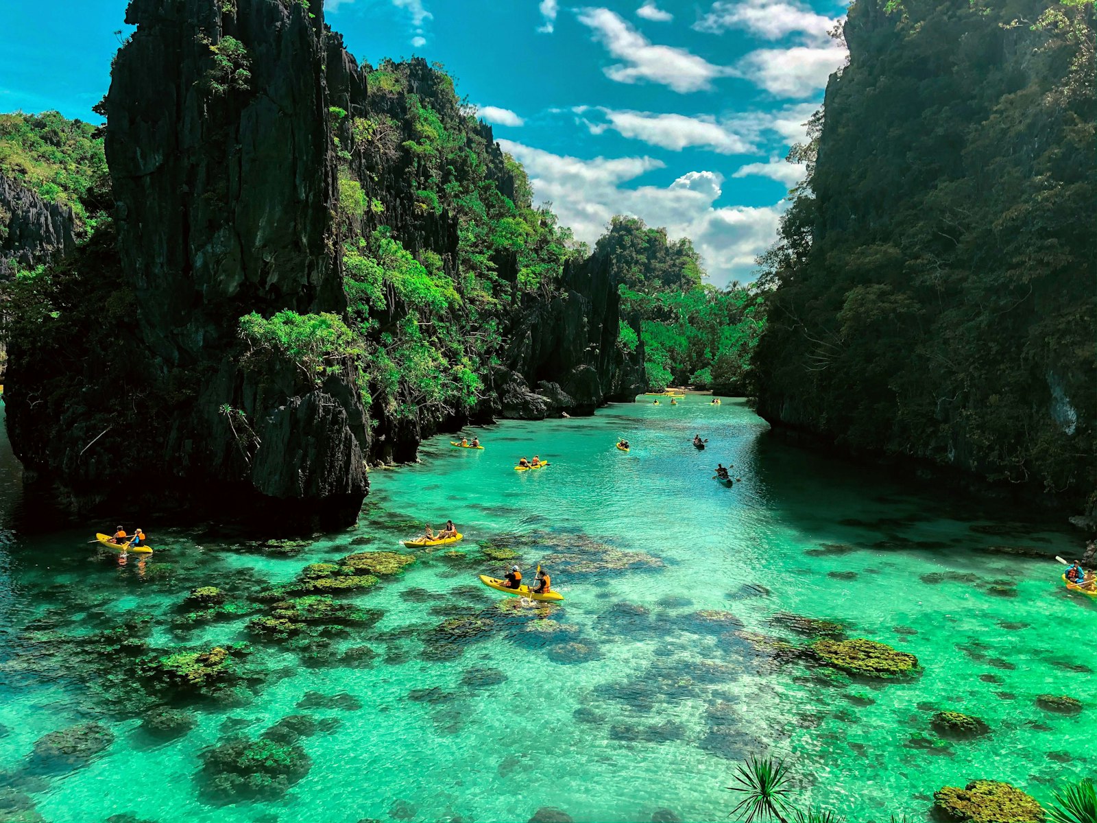 Swimmers among limestone rocks on El Nido Tour B, similar to the Cathedral Cave stop