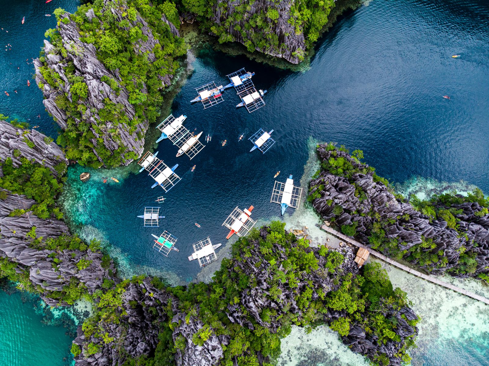 Bangka boats in a turquoise lagoon on El Nido Tour D, Bacuit Bay Palawan Philippines