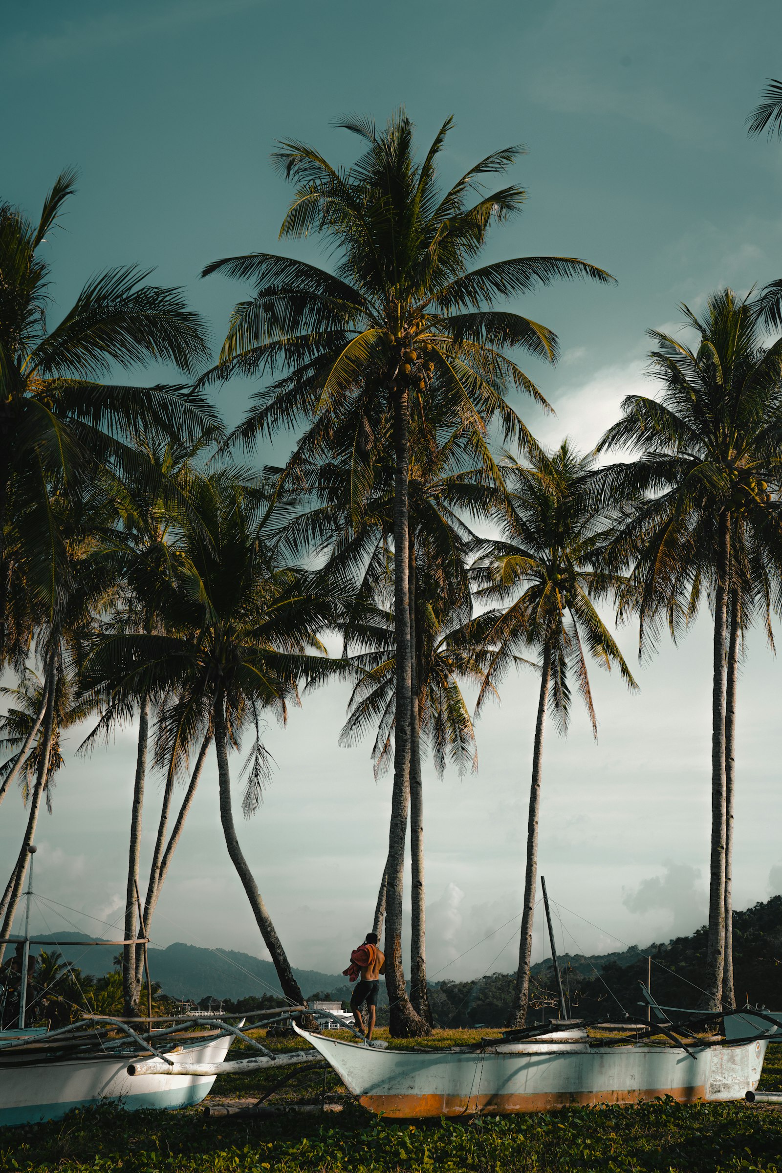 Palm-fringed beach with boats in El Nido, Palawan, near Tour D's Ipil Beach stop