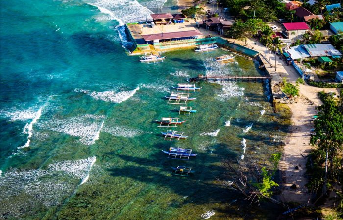 Aerial view of Port Barton beach village with boats moored along the coast Palawan
