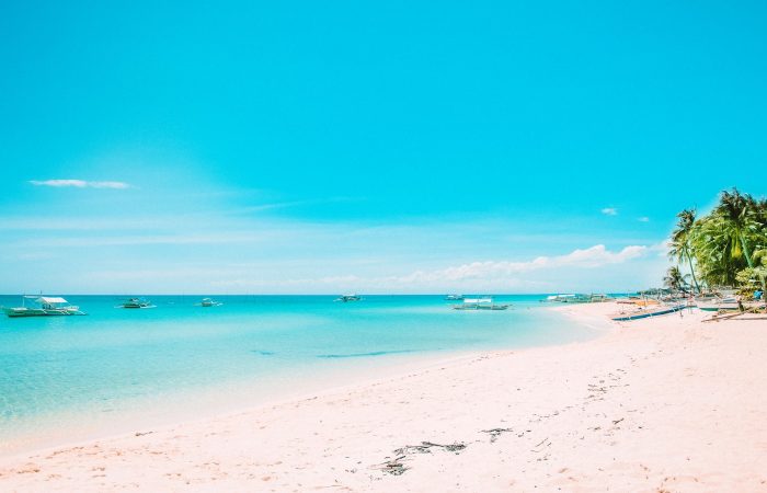 Quiet uncrowded beach with boats in Port Barton Palawan Philippines