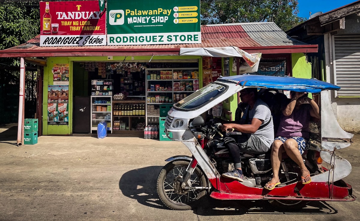 Tricycle passing a store in Puerto Princesa, Palawan, Philippines