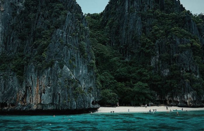 Limestone cliffs and turquoise cove near Small Lagoon El Nido Palawan Bacuit Bay