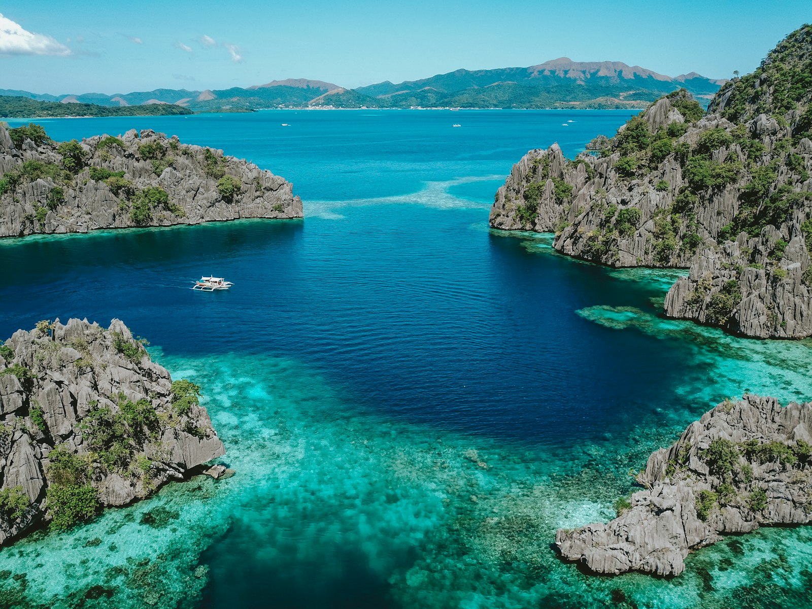 Aerial view of Coron Palawan limestone islands and clear blue sea on the boat route to Barracuda Lake