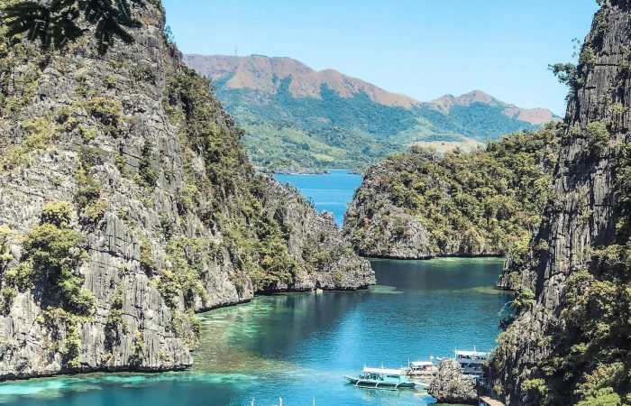 Boats floating on the clear water at Kayangan Lake, Coron, Palawan, the Philippines top island hopping stop
