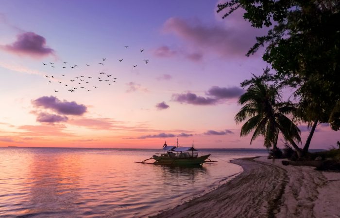 Single bangka boat on an empty Balabac shoreline in southern Palawan