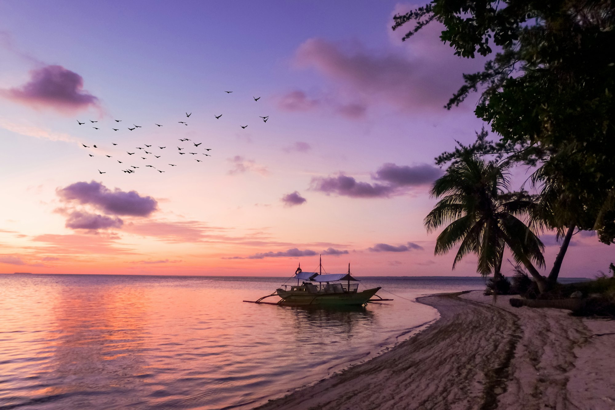 Single bangka boat on an empty Balabac shoreline in southern Palawan