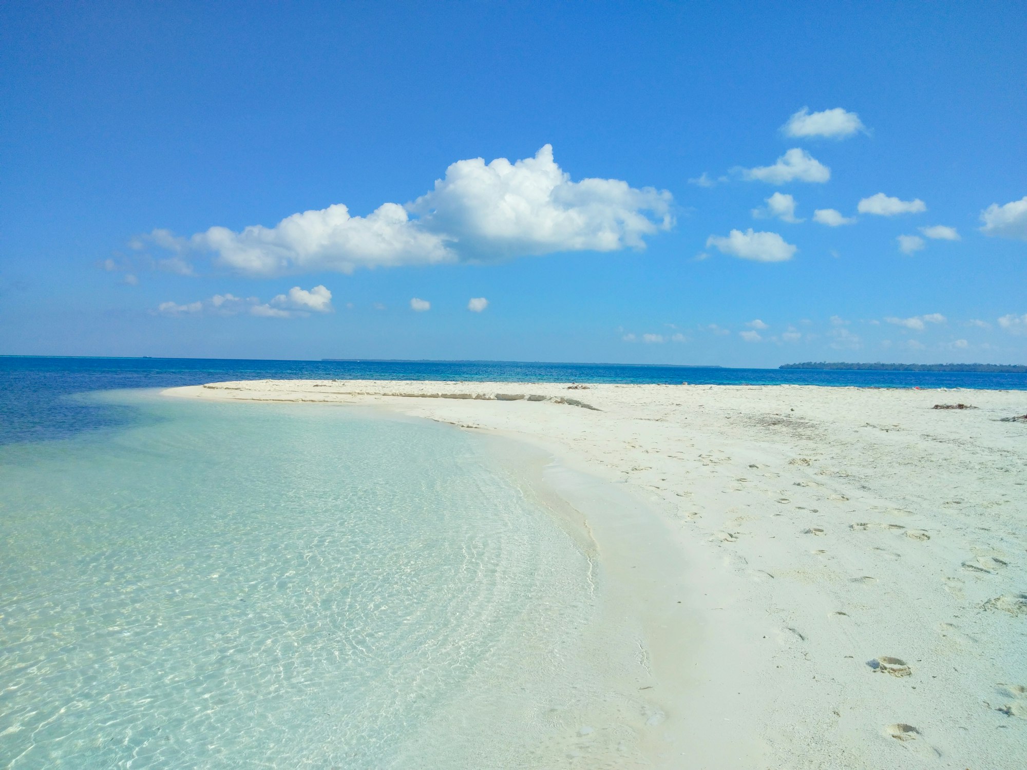 White sand beach and clear shallow water on a Balabac island in Palawan