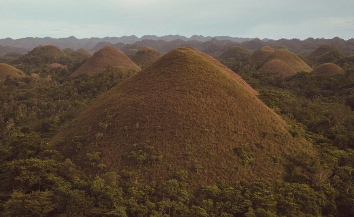 The Chocolate Hills of Bohol under a cloudy sky