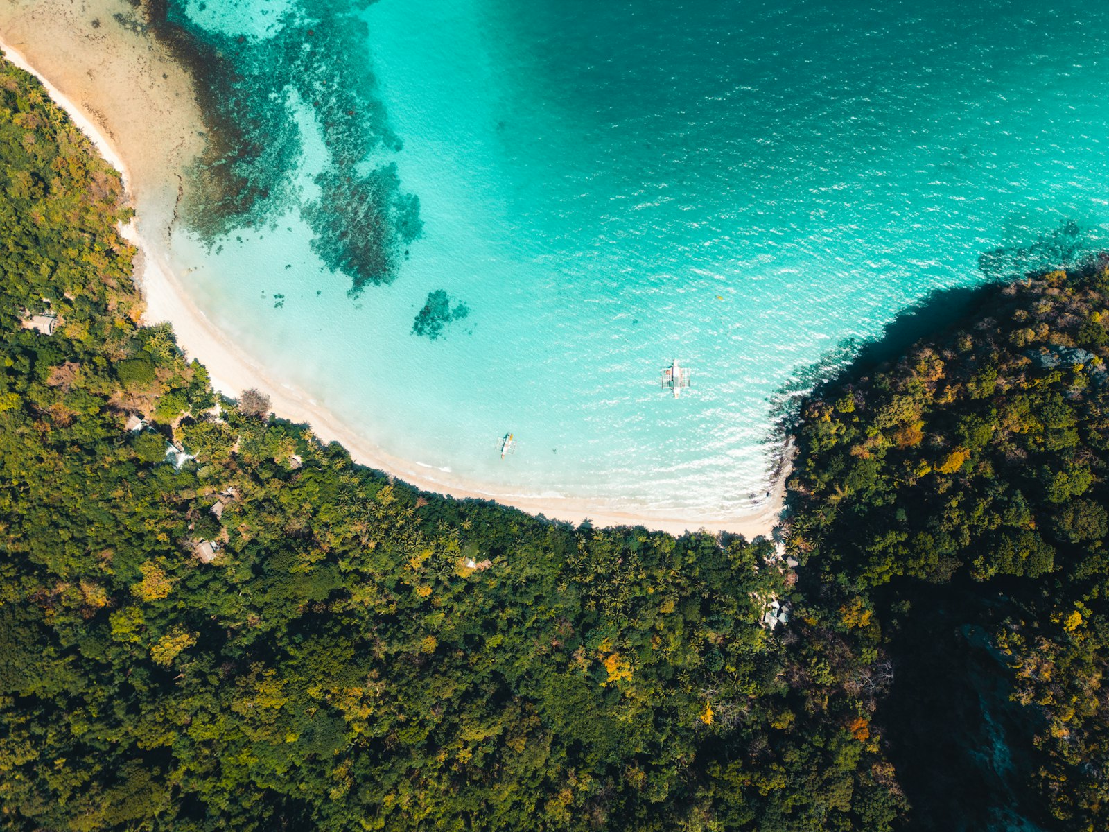 Aerial view of El Nido beach and boats, the island hopping tours that dominate any El Nido budget per day