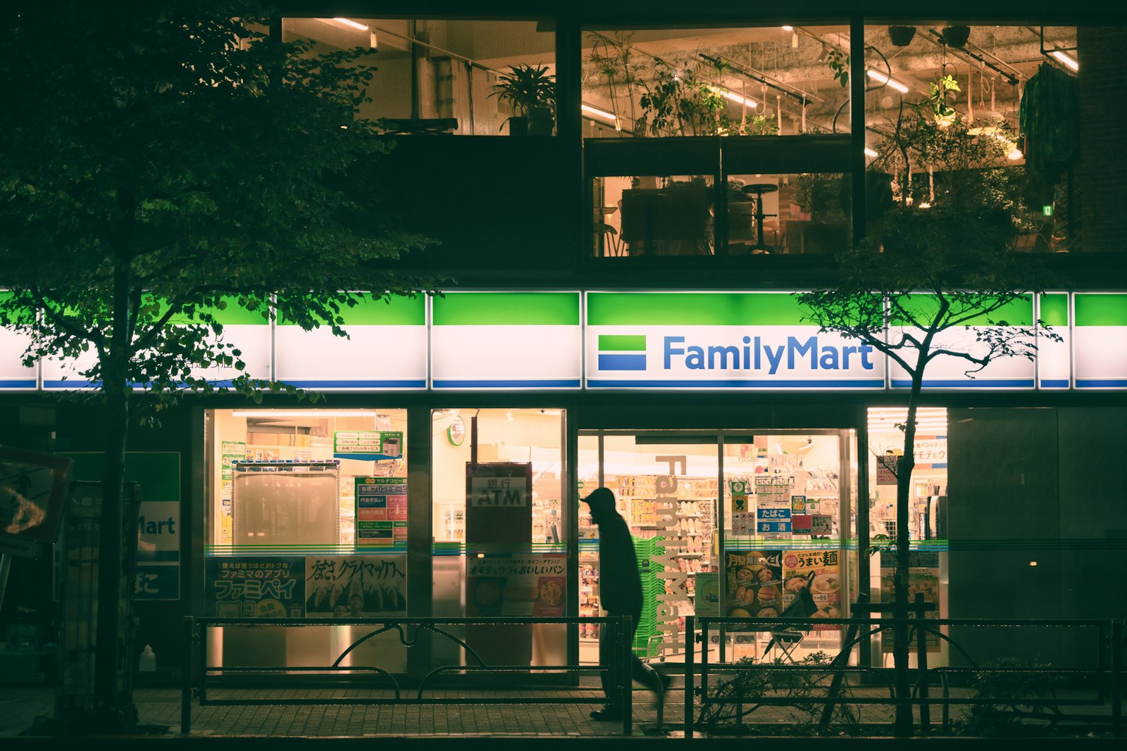 FamilyMart convenience store lit up at night in Tokyo, a cheap food option in a Japan trip cost guide