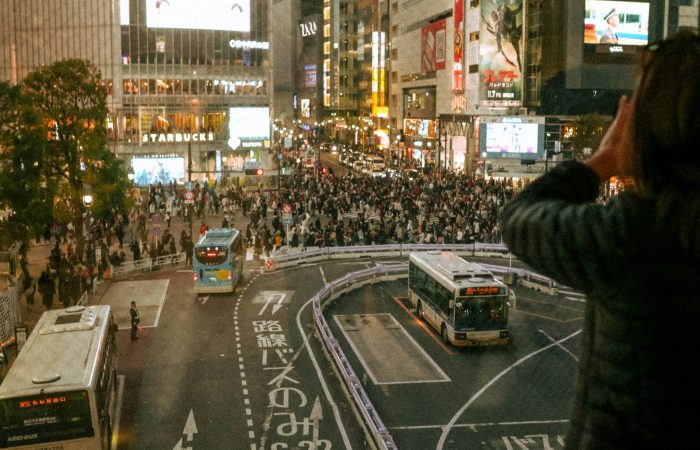 Crowds at Shibuya Crossing in Tokyo at night, planning a Japan trip cost from the Philippines