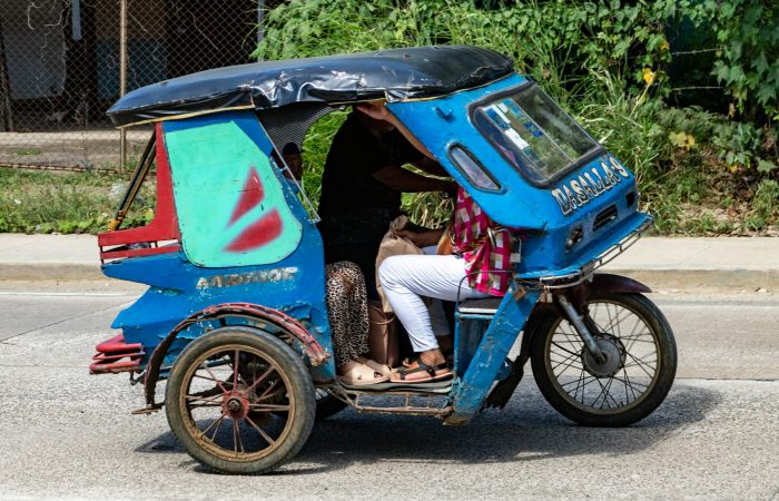 Tricycle on a sunny road in Puerto Princesa, the starting point for Port Barton budget travel by shared van