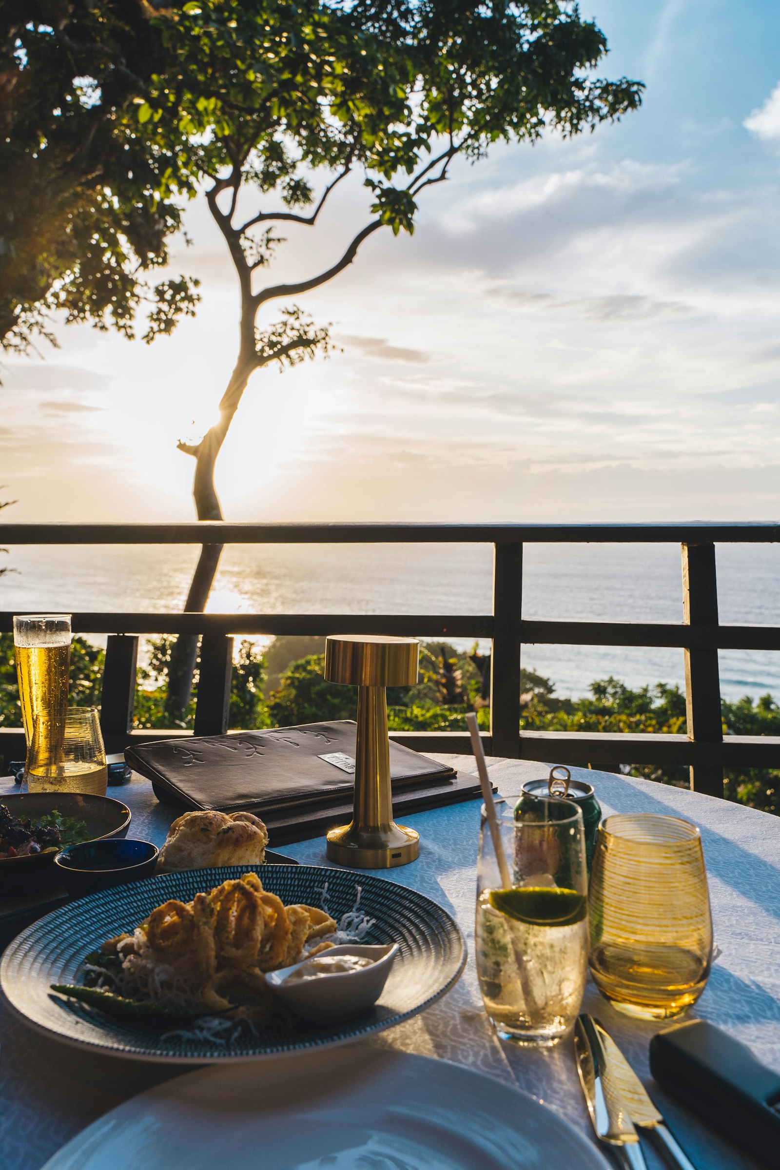 A plate of food on a table overlooking the sea, typical of beachfront Port Barton restaurants